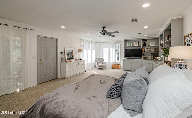 carpeted bedroom with a ceiling fan, recessed lighting, visible vents, and crown molding