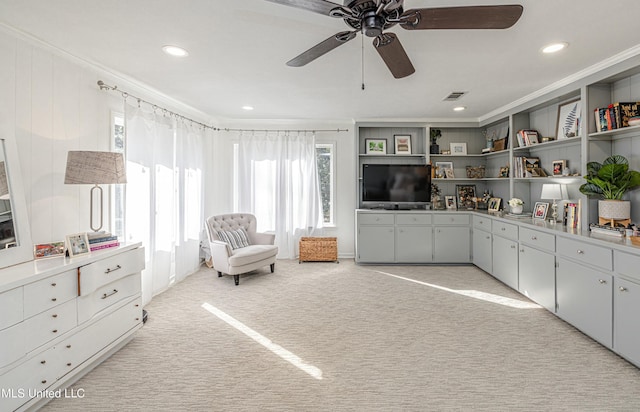 sitting room featuring ceiling fan, recessed lighting, light carpet, visible vents, and crown molding