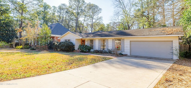 ranch-style home with a garage, concrete driveway, and a front yard