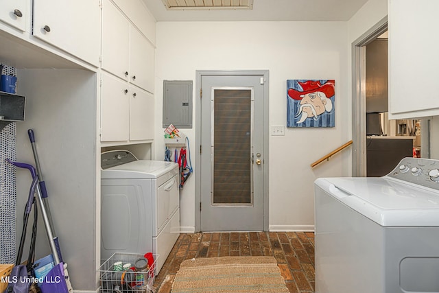 laundry room with brick floor, electric panel, cabinet space, and separate washer and dryer