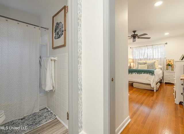 bathroom featuring curtained shower, recessed lighting, and wood finished floors