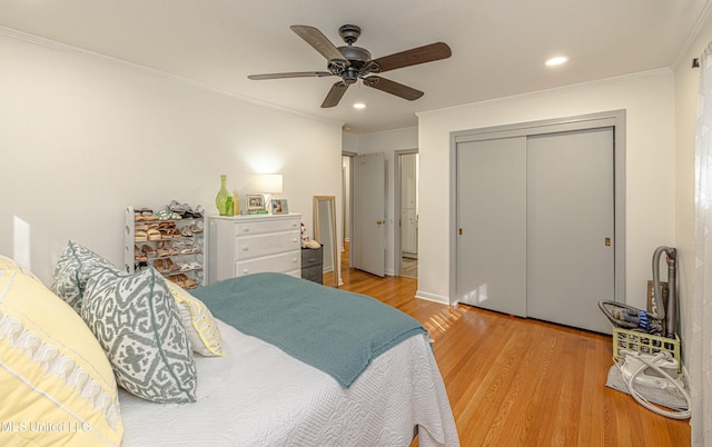 bedroom with ornamental molding, a closet, wood finished floors, and recessed lighting