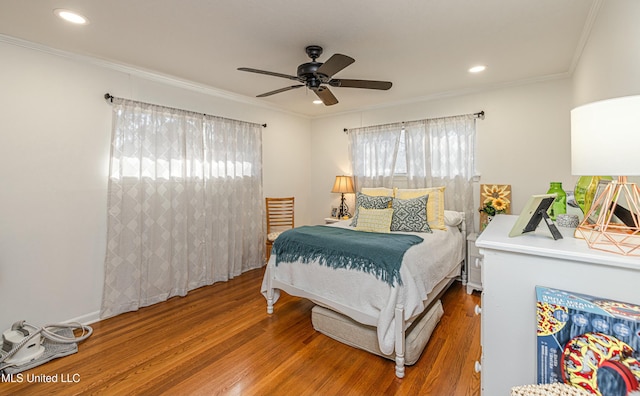 bedroom featuring a ceiling fan, recessed lighting, crown molding, and wood finished floors