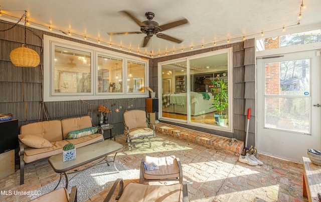 sunroom with a ceiling fan