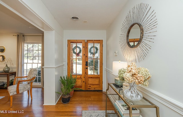 doorway featuring visible vents, wood finished floors, and french doors