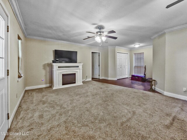 unfurnished living room featuring carpet floors, a ceiling fan, and crown molding