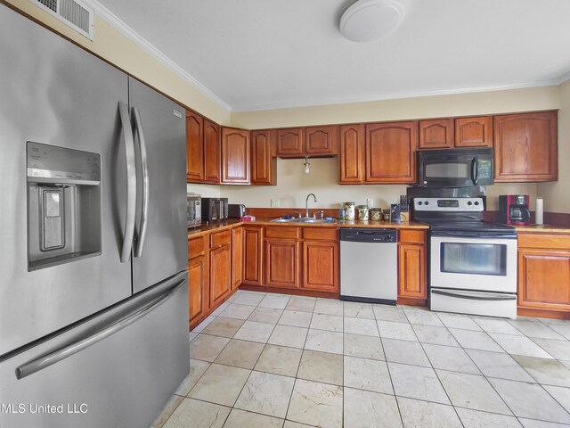 kitchen with a sink, crown molding, stainless steel appliances, and brown cabinets