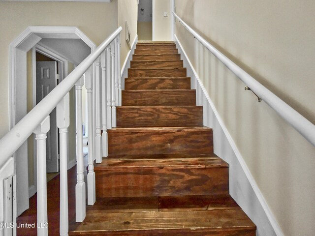 staircase with wood finished floors