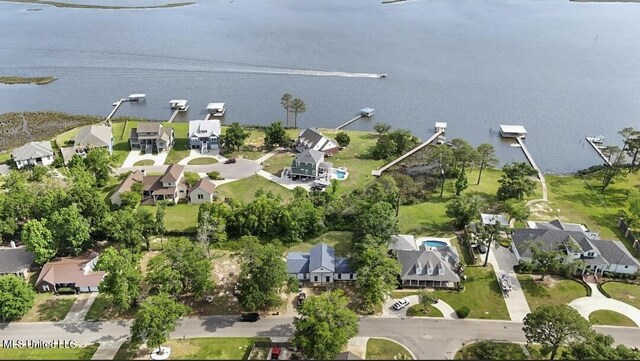 birds eye view of property with a water view and a residential view