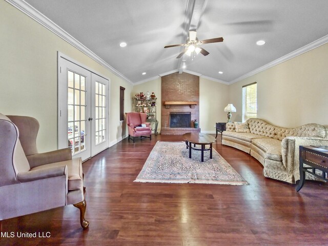 living area featuring crown molding, french doors, a ceiling fan, dark wood-type flooring, and vaulted ceiling