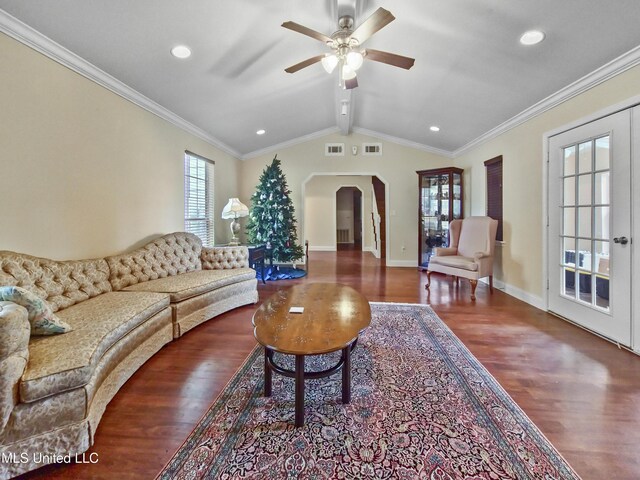 living room with arched walkways, ceiling fan, wood finished floors, and visible vents