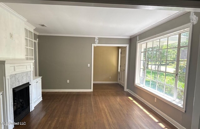 unfurnished living room with crown molding and dark hardwood / wood-style floors