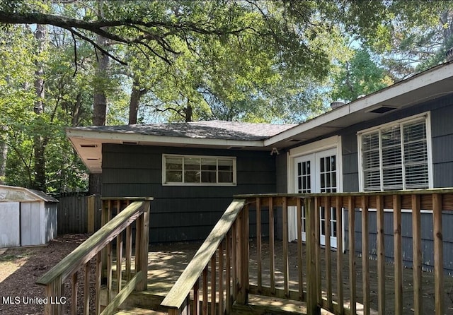 wooden terrace with a storage shed