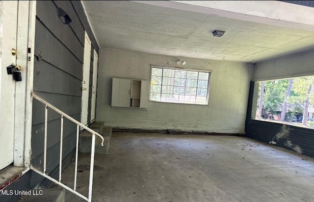 spare room with concrete flooring and plenty of natural light