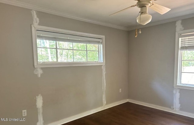 spare room with ornamental molding, ceiling fan, and dark hardwood / wood-style flooring