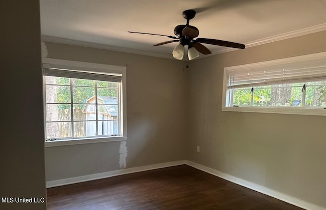 unfurnished room featuring ceiling fan, ornamental molding, a wealth of natural light, and dark hardwood / wood-style flooring