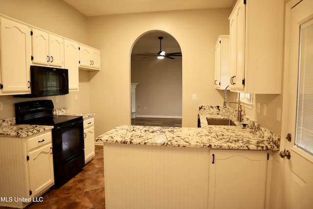 kitchen with black appliances, a ceiling fan, a peninsula, a sink, and light stone countertops