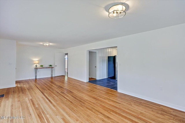 unfurnished room featuring hardwood / wood-style floors