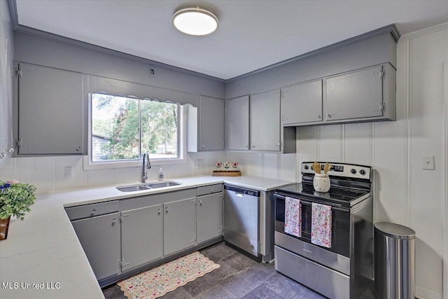 kitchen with gray cabinetry, sink, ornamental molding, and stainless steel appliances