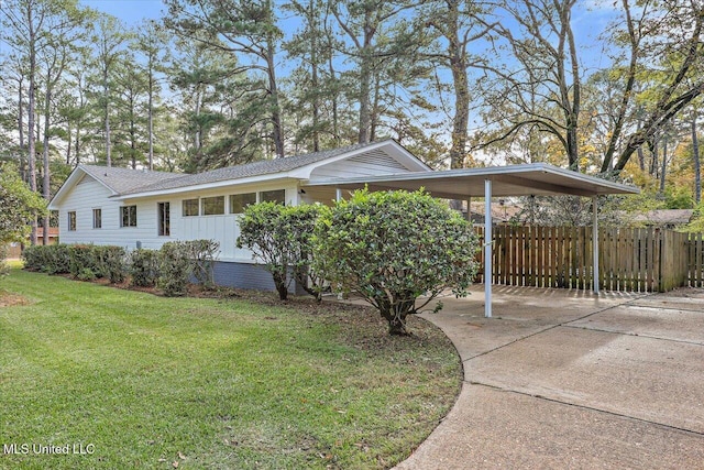 view of property exterior featuring a yard and a carport