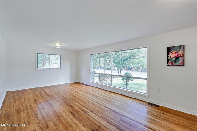 spare room featuring light hardwood / wood-style floors