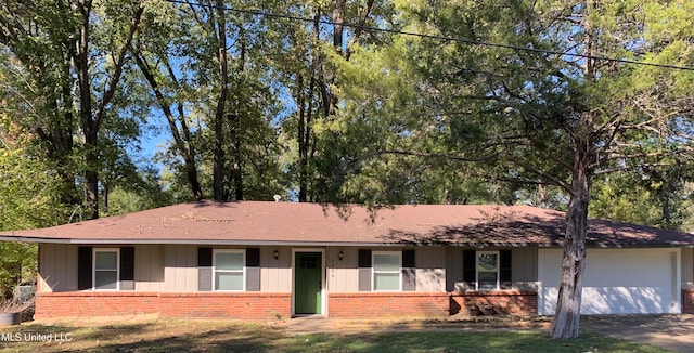 ranch-style home with a garage and a front yard