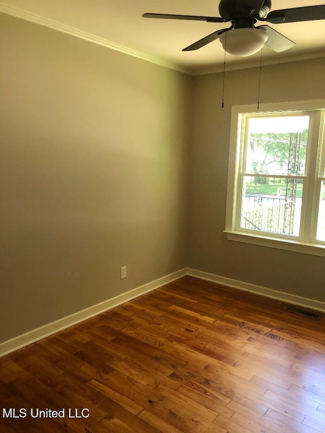 214 Evelyn St, Senatobia, MS 38668 - unfurnished room with ornamental molding, dark wood-style flooring, baseboards, and a ceiling fan