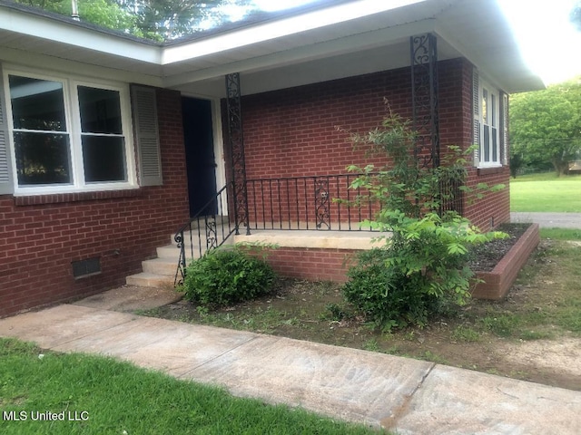 214 Evelyn St, Senatobia, MS 38668 - view of front of house with crawl space and brick siding