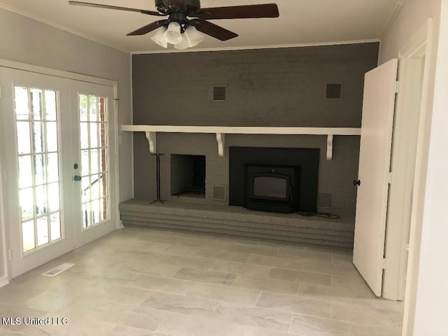 214 Evelyn St, Senatobia, MS 38668 - unfurnished living room featuring ornamental molding, french doors, a brick fireplace, and ceiling fan