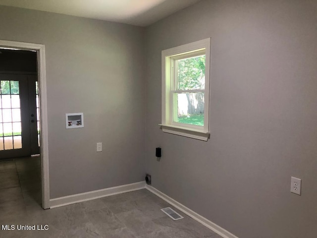 214 Evelyn St, Senatobia, MS 38668 - laundry area with hookup for a washing machine, healthy amount of natural light, and baseboards