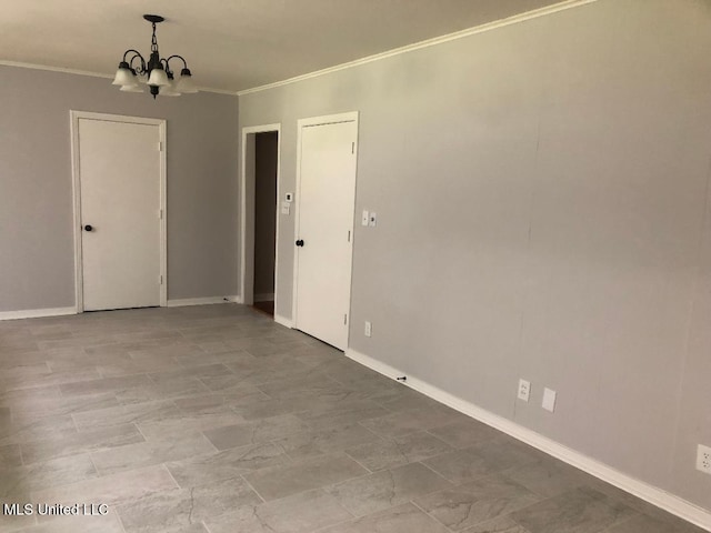 214 Evelyn St, Senatobia, MS 38668 - empty room featuring a chandelier, crown molding, and baseboards