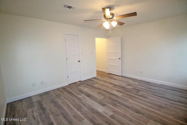 unfurnished room with dark wood-type flooring