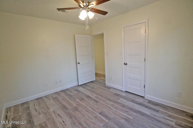 unfurnished bedroom with ceiling fan and light hardwood / wood-style floors