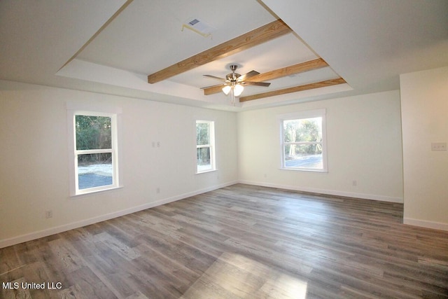 spare room with hardwood / wood-style flooring, ceiling fan, and a tray ceiling