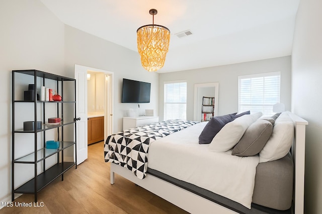 1177 Chestnut Dr, Southaven, MS 38671 - bedroom featuring multiple windows, light wood-style floors, and a chandelier