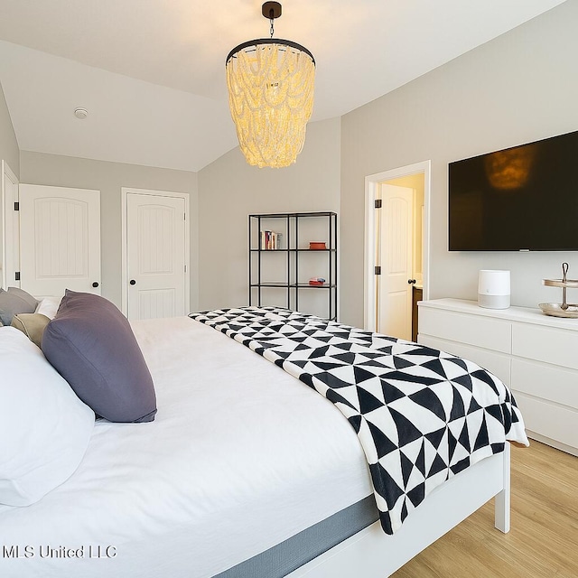 1177 Chestnut Dr, Southaven, MS 38671 - bedroom with light wood finished floors and a chandelier