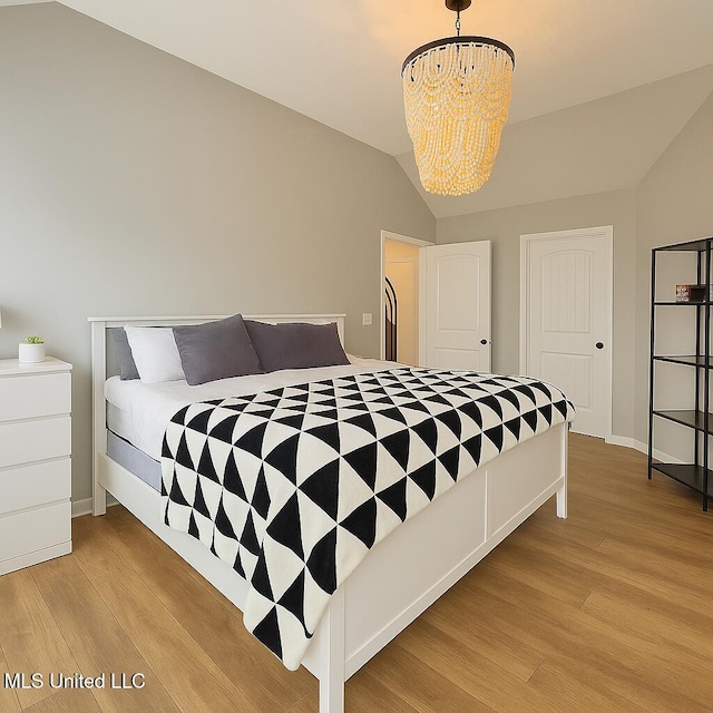 1177 Chestnut Dr, Southaven, MS 38671 - bedroom featuring light wood-style floors, a chandelier, and lofted ceiling