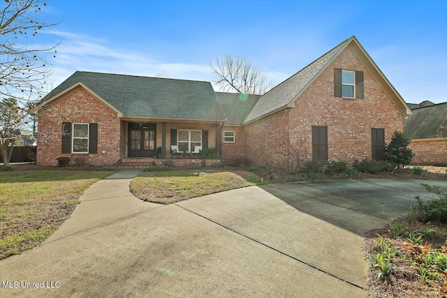 view of front of property with brick siding and a front lawn