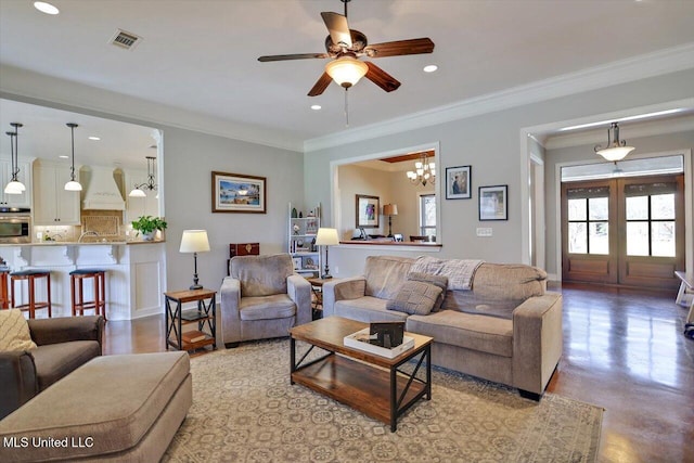 living area with visible vents, a ceiling fan, finished concrete flooring, recessed lighting, and crown molding