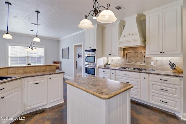 kitchen with stainless steel appliances, concrete flooring, visible vents, and custom range hood