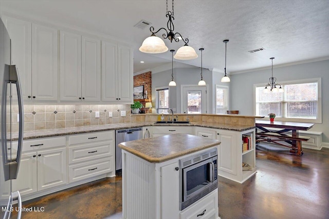 kitchen featuring stainless steel appliances, a peninsula, visible vents, and finished concrete floors