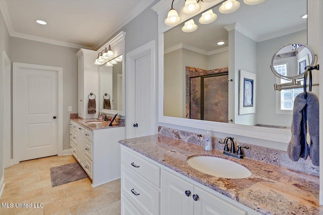 full bathroom with crown molding, a stall shower, and a sink