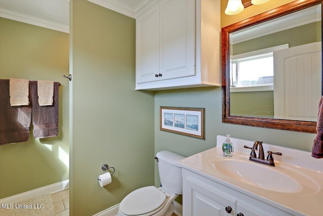 half bath featuring baseboards, toilet, ornamental molding, and vanity