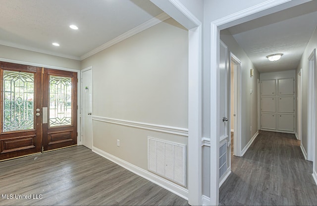 entrance foyer featuring french doors, crown molding, a textured ceiling, and dark hardwood / wood-style flooring