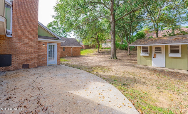 view of yard with a patio area and an outbuilding