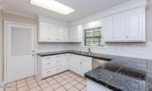 kitchen with backsplash, dishwasher, sink, and white cabinets