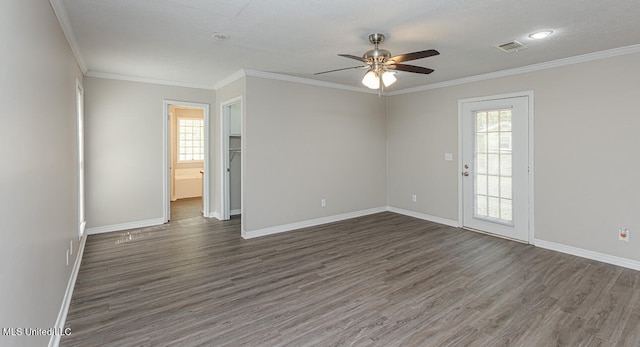 spare room featuring ornamental molding, dark wood-type flooring, and ceiling fan