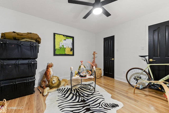 office featuring ceiling fan, wood finished floors, and baseboards