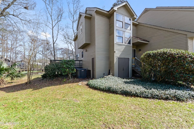 view of home's exterior with a lawn and central air condition unit