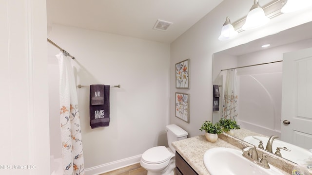 bathroom with tile patterned floors, a shower with curtain, vanity, and toilet